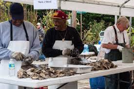 Local watermen shucking oysters during Fallfest