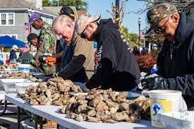 Kent County Commissioner Ron Fithian serves up oysters during Fallfest