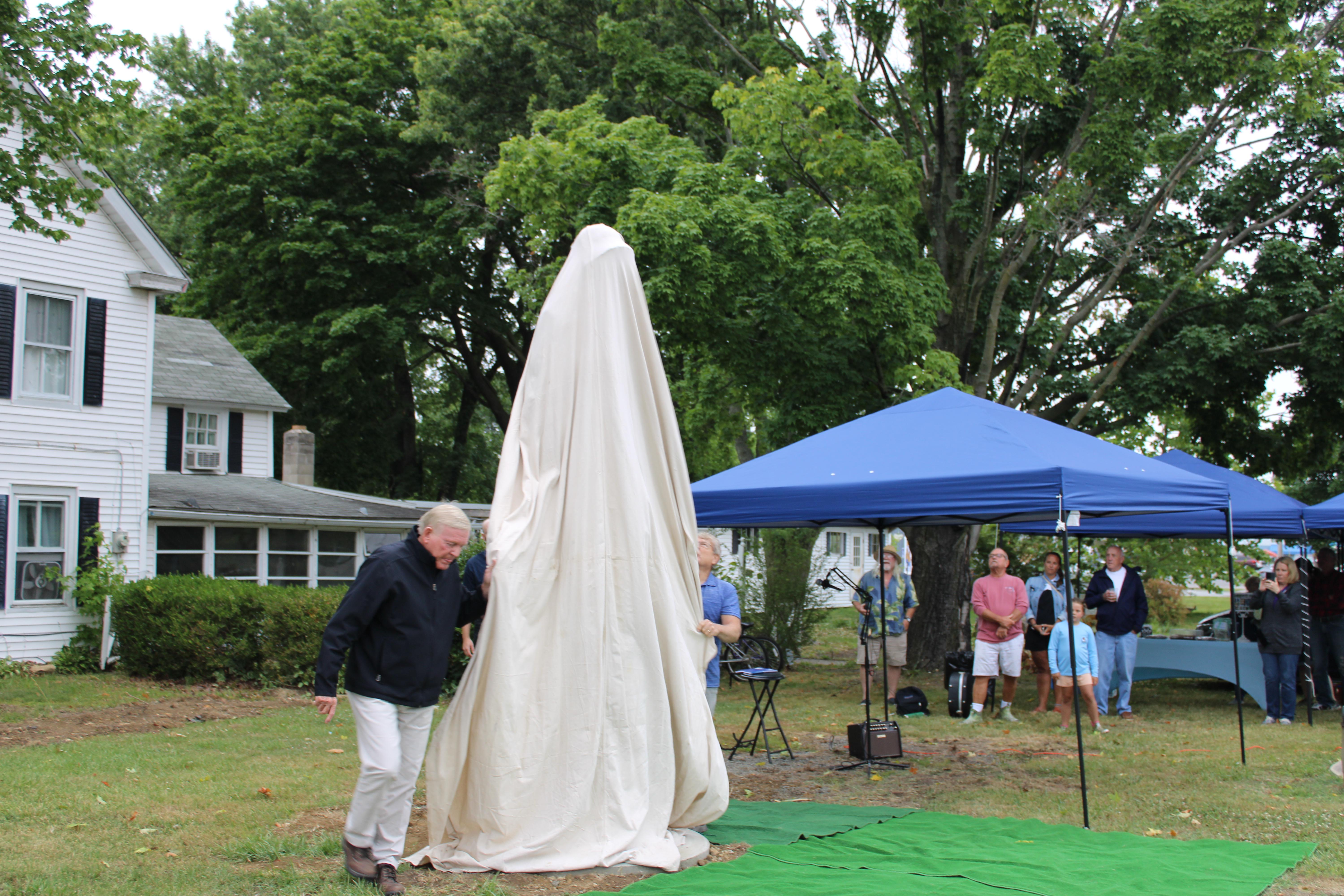 The restoration artist John Elburn and Kent County Commissioner Ron Fithian prepare to unveil the restored Old Salt